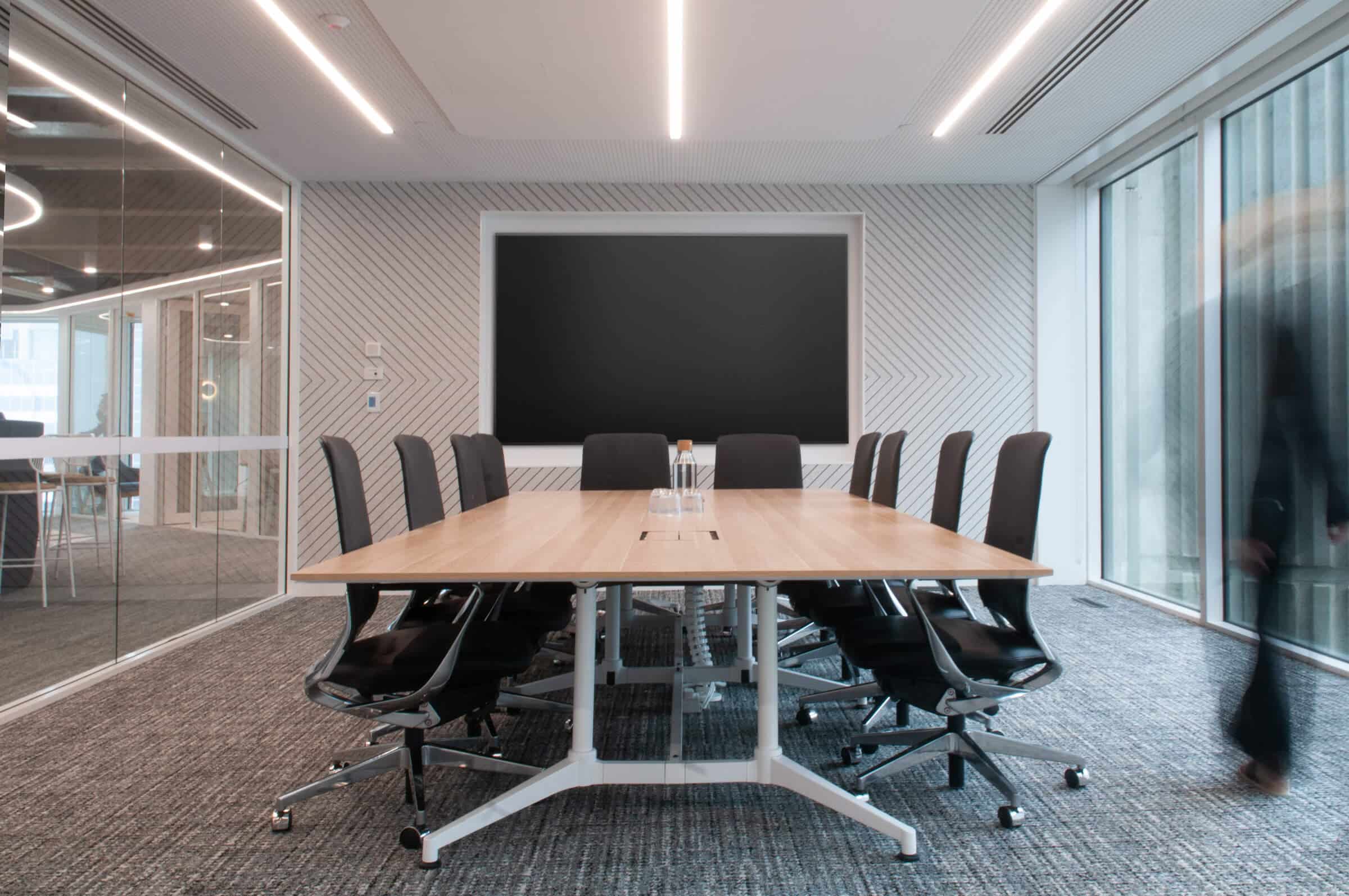 Modern meeting room area with a spacious table, designed for collaboration in a professional setting.