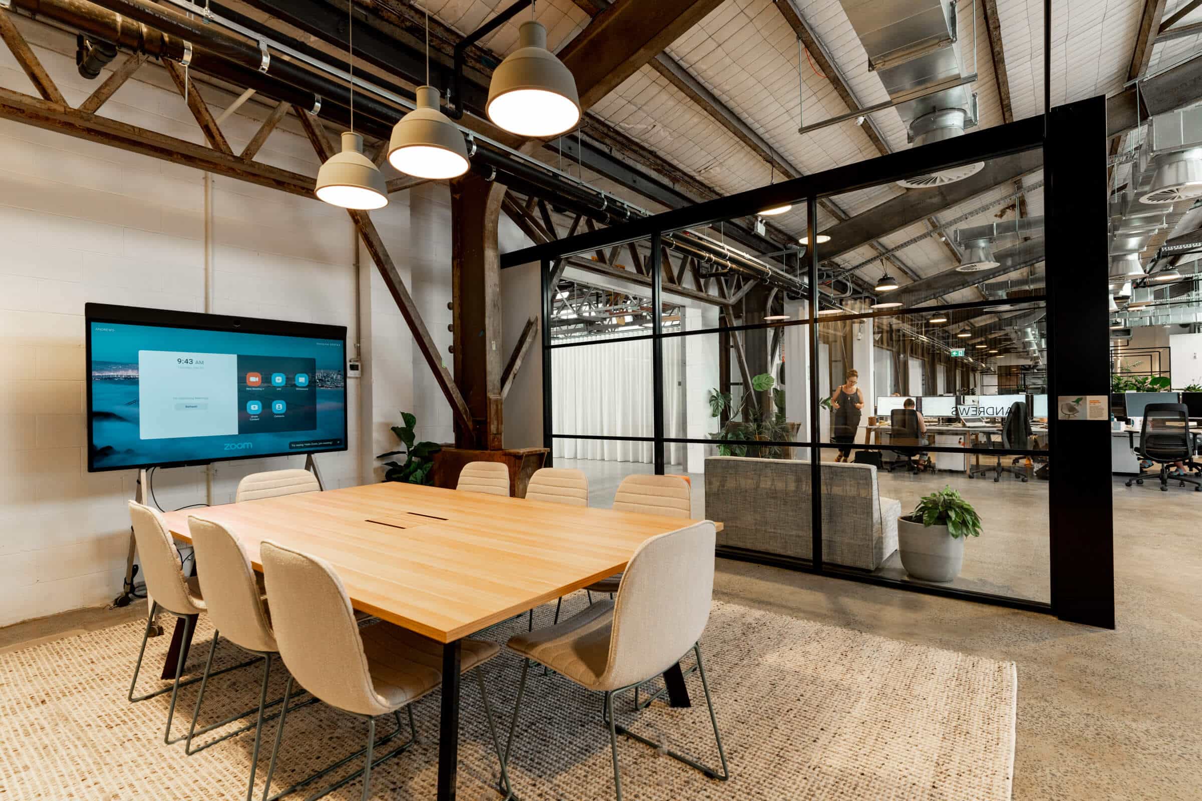 Modern meeting room area with a spacious table, designed for collaboration in a professional setting.