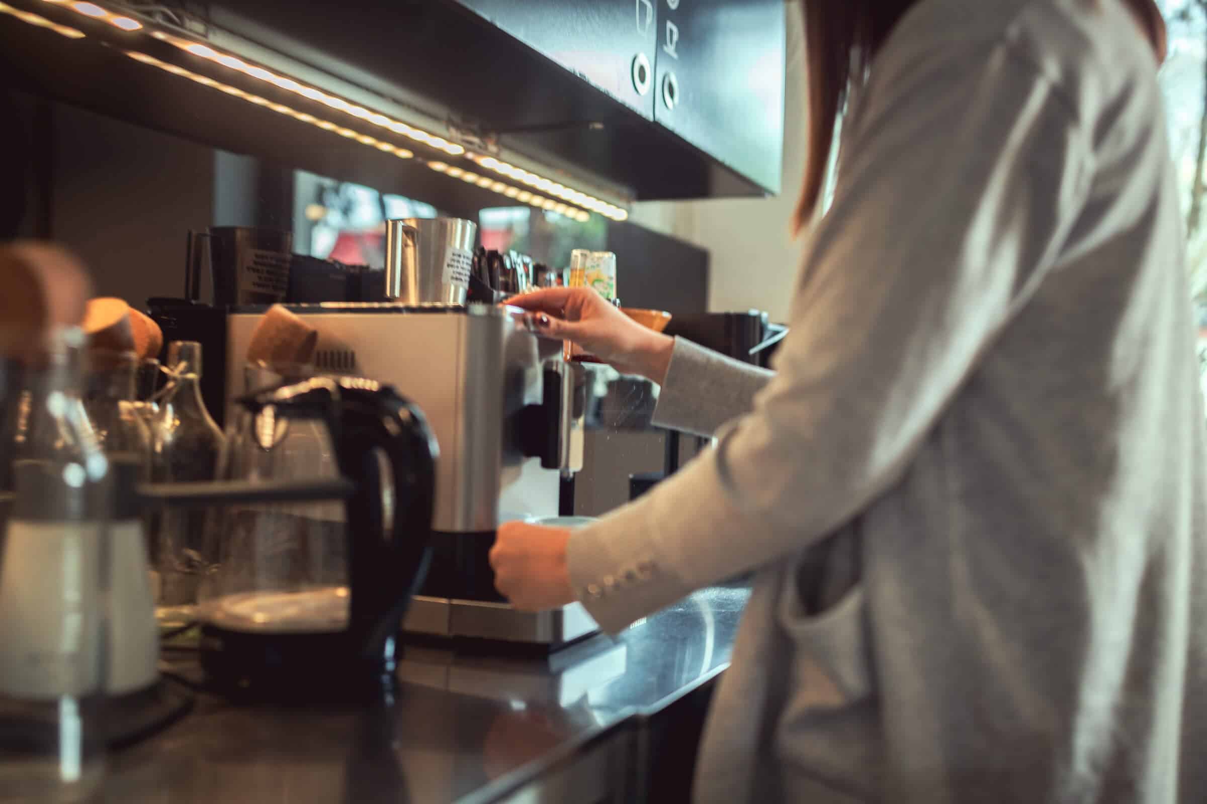 Close up of woman making coffee