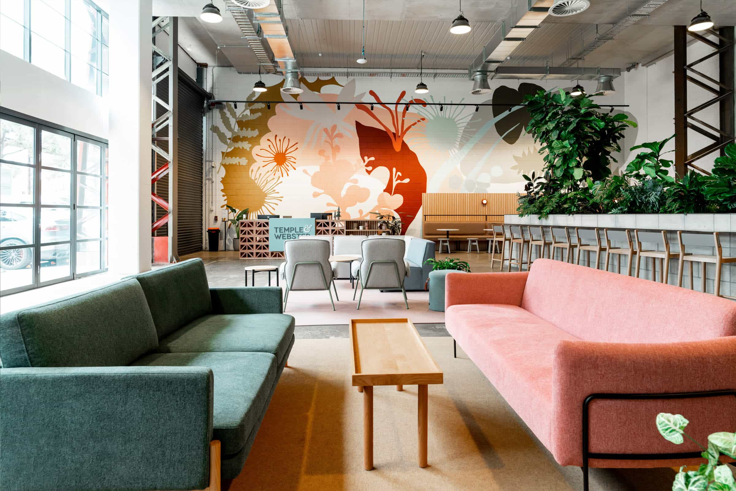 Elegant office reception featuring large windows, natural lighting, and modern furnishings, creating a professional and inviting atmosphere.