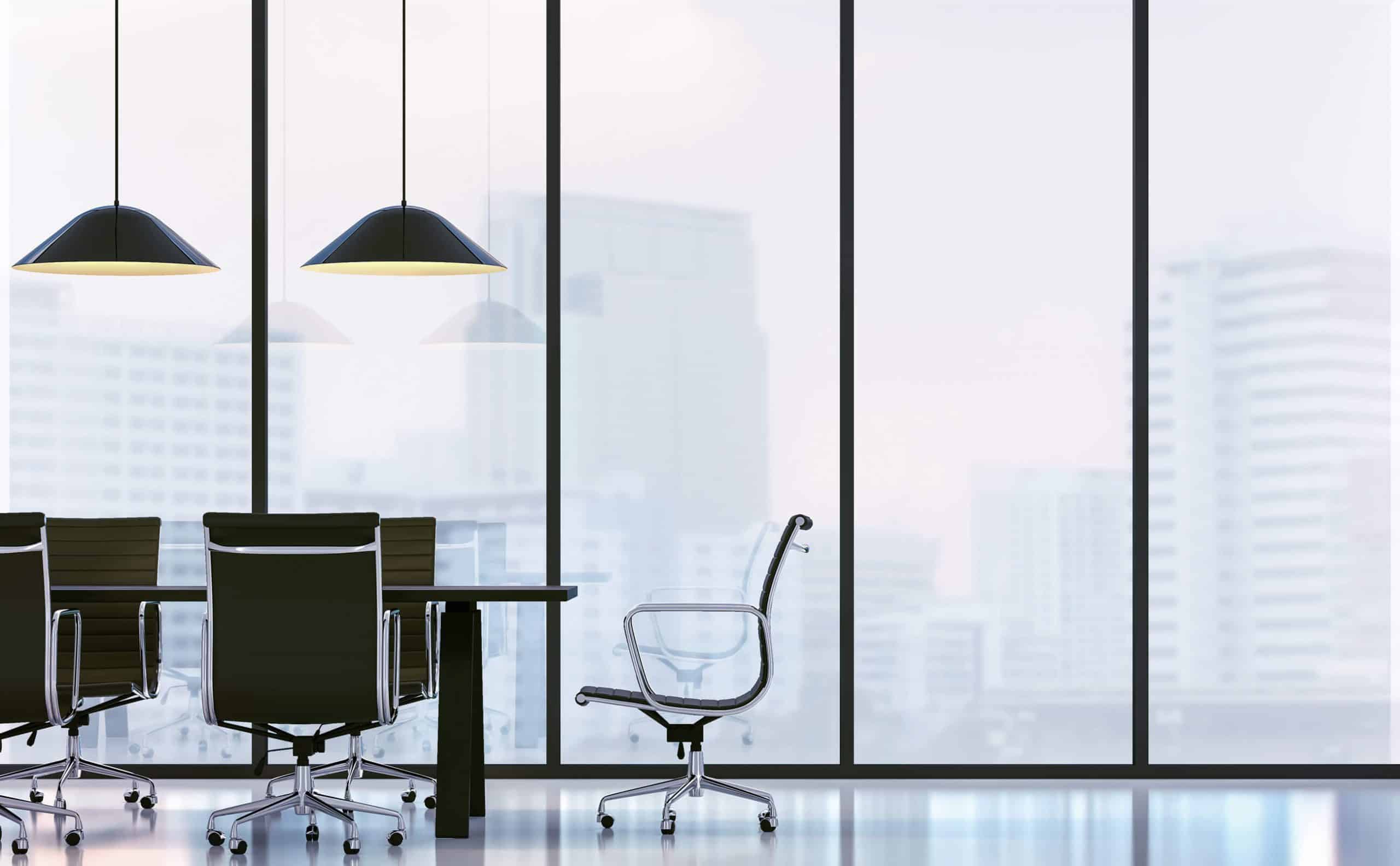 Modern meeting room area with a spacious table, designed for collaboration in a professional setting and large windows allowing for natural light.