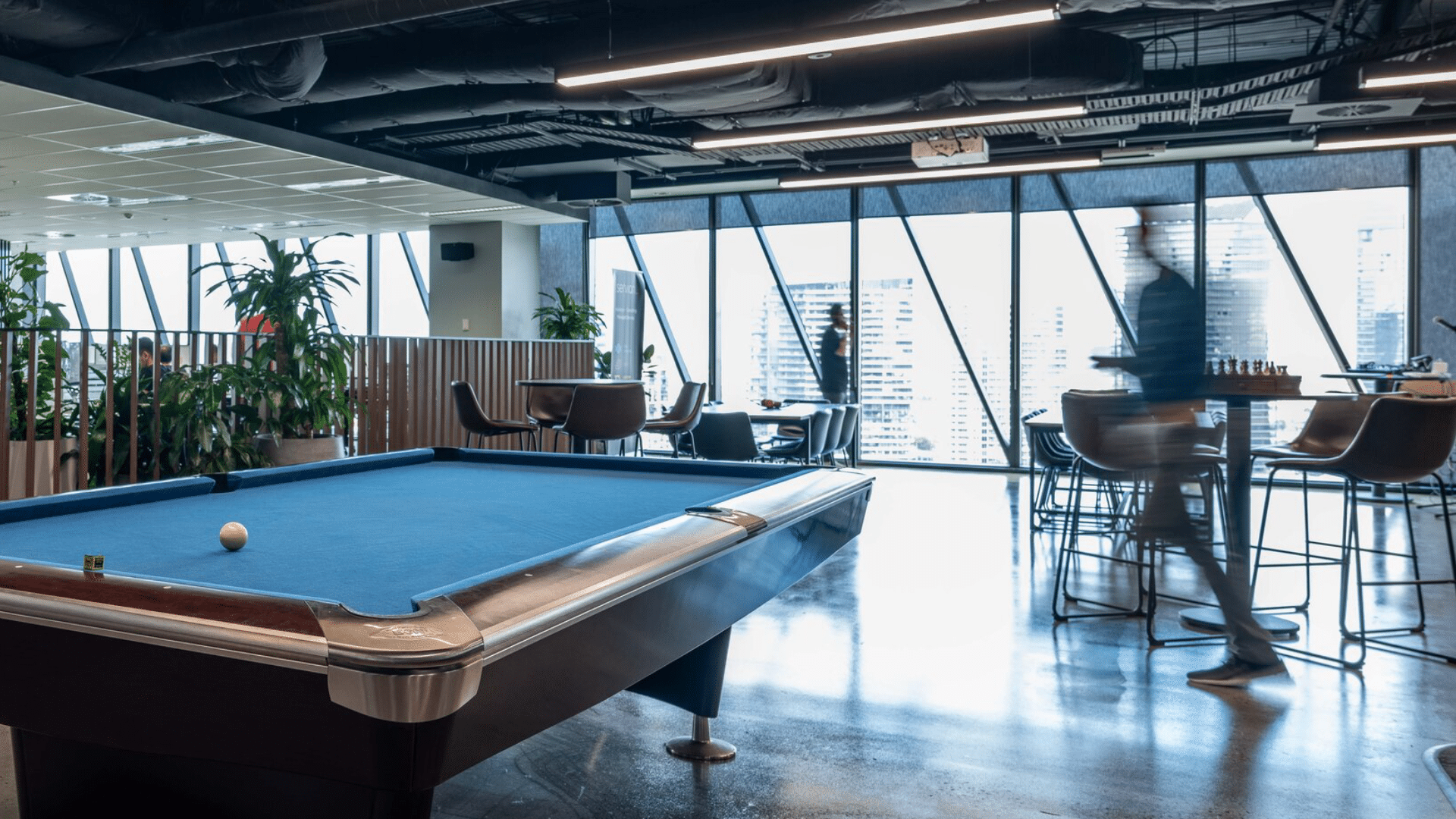 Contemporary break out space with a pool table and various seating for employees to unwind.