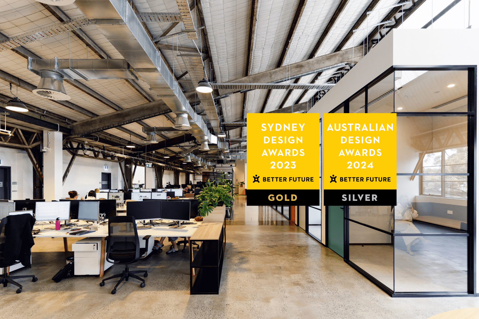 Stylish office with modern furniture, warm lighting, and an open layout. Awards for Australian and Sydney Design displayed in the foreground.