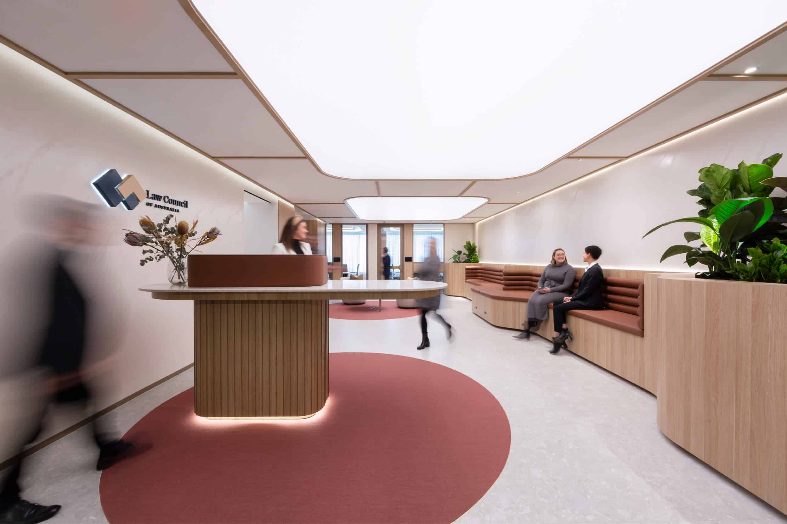 Stylish office reception with modern furniture, warm lighting, and an open layout.