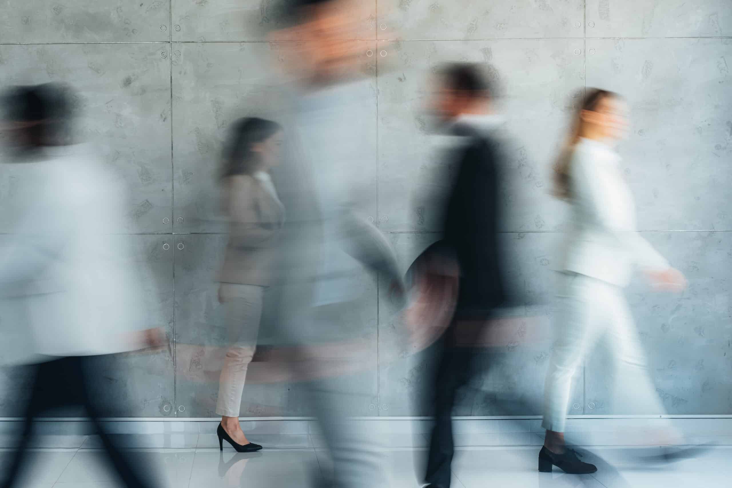 Busy modern workplace. Working process in the office, business people working, walking and talking, blurred motion