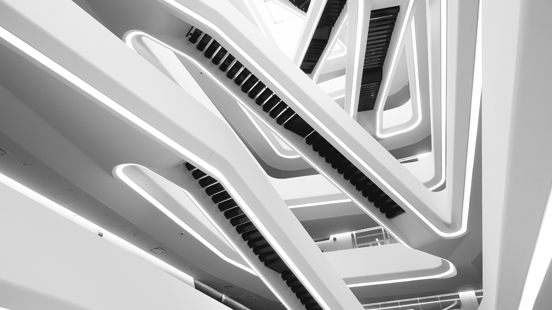 A set of white multi-level stairs with a sleek, modern design