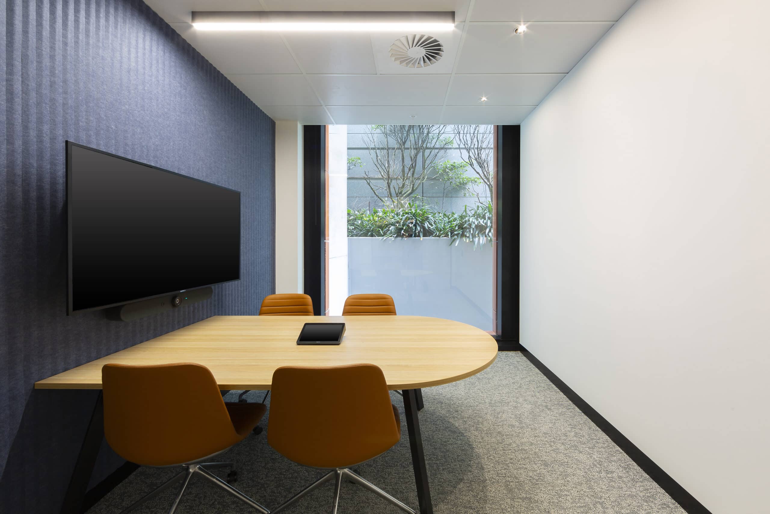 Modern meeting room area with a spacious table, designed for collaboration in a professional setting.