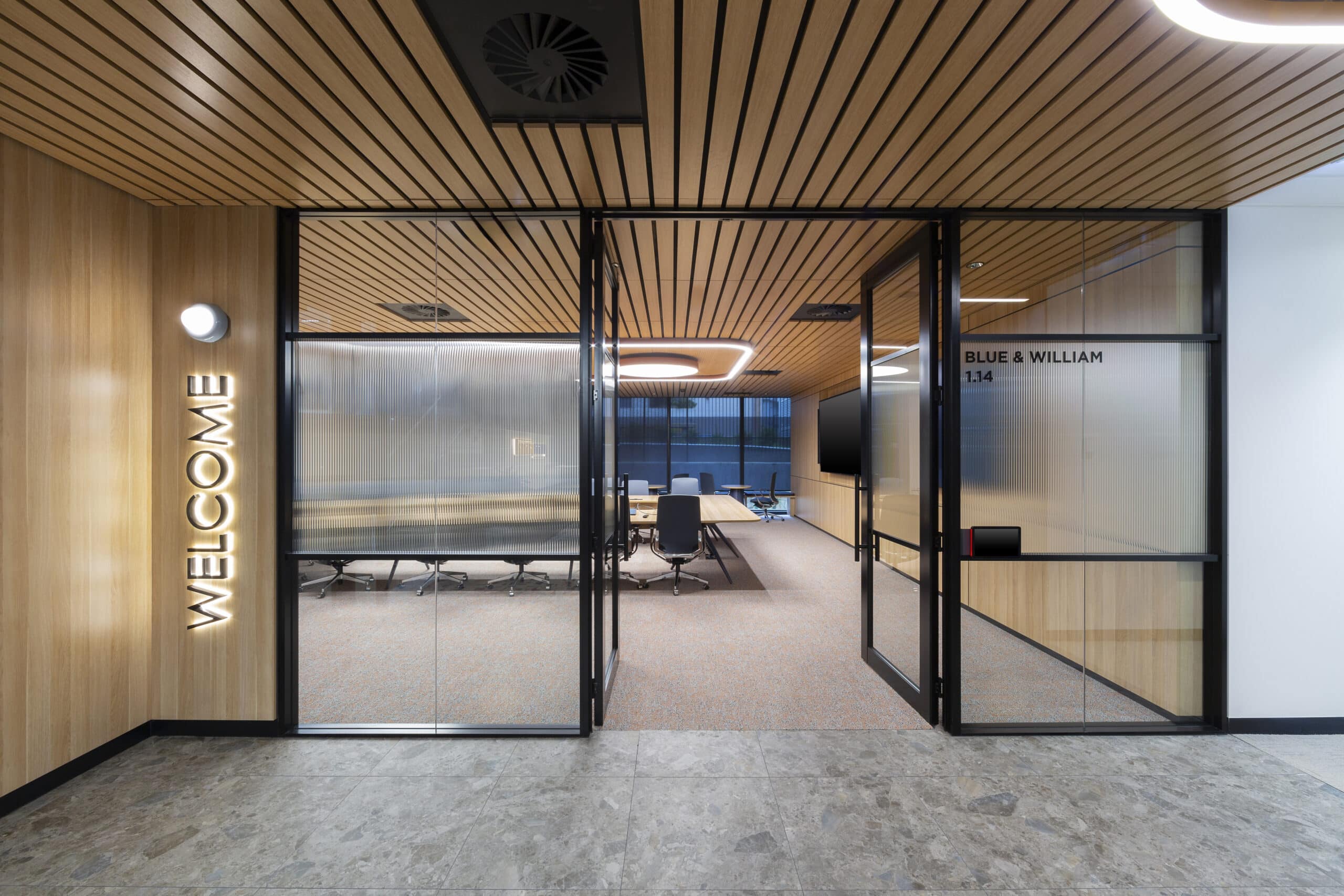 Modern meeting room area with a spacious table, designed for collaboration in a professional setting.